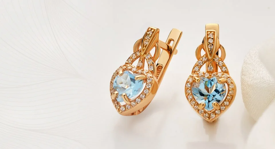 Rose gold heart earrings with blue topaz